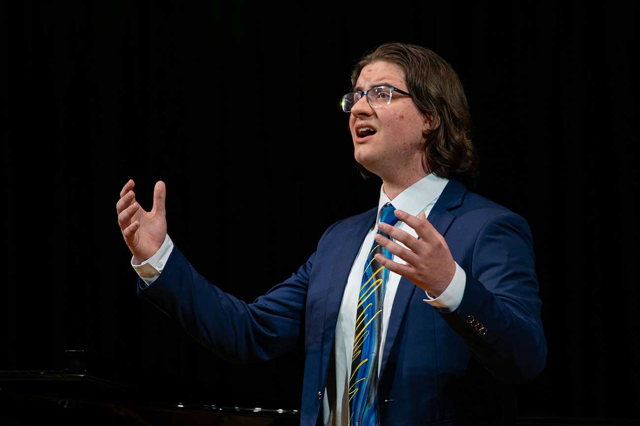 Xander singing on stage during his junior recital